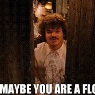 a man with a mustache and moustache standing in a doorway