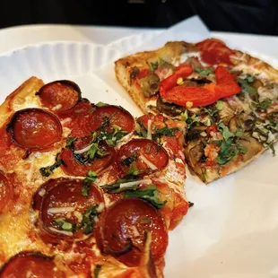two slices of pizza on a paper plate