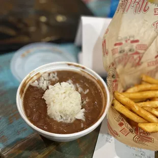 a bowl of chili and french fries