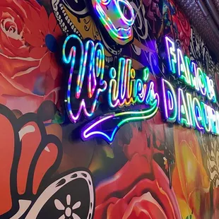 a neon sign for willie&apos;s chicken shack