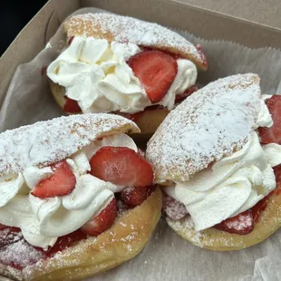 Fresh donuts filled with homemade Bavarian cream and fresh strawberries, and strawberry sauce