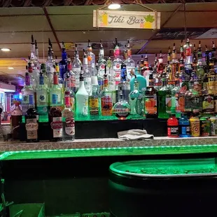 a row of liquor bottles on the bar
