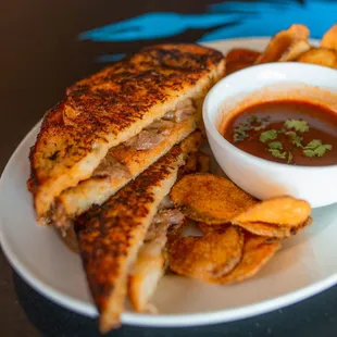 BIRRIA GRILLED CHEESE: Birria beef and pepper jack grilled cheese with a side of Birria broth