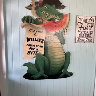 a crocodile holding a piece of watermelon