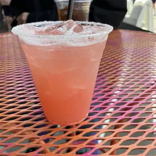 Strawberry margarita on the rocks sugar rim.