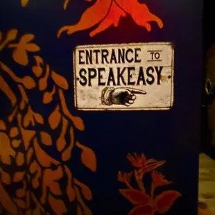 a sign that reads entrance to speakeasy
