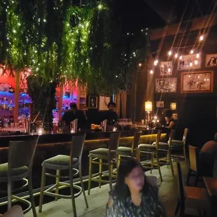 people sitting at a bar in a dimly lit room