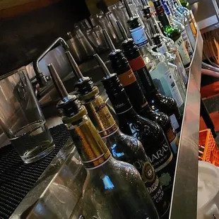 a bar counter with bottles of alcohol