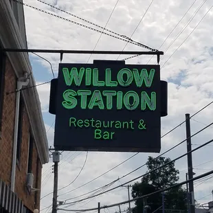a neon sign for a restaurant and bar
