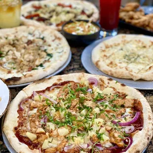 BBQ Chicken Pizza, Garlic Chicken Pizza, Wood-Fired Garlic Bread, and Artichoke and Garlic Cream Pizza