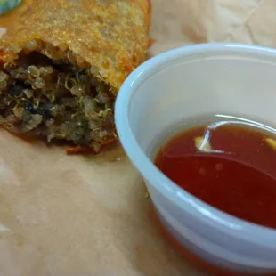 a burrito and a cup of ketchup