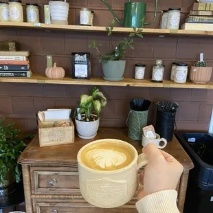 a person holding a cup of coffee