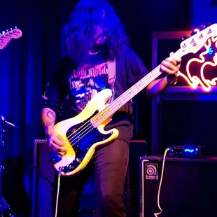 a man playing a bass guitar