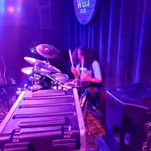 a man playing drums on stage