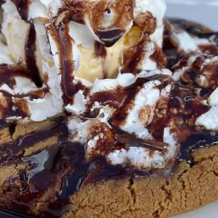 a cookie with ice cream and chocolate sauce