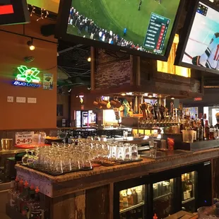 a sports bar with many televisions