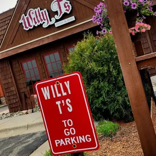 a red and white sign in front of a restaurant