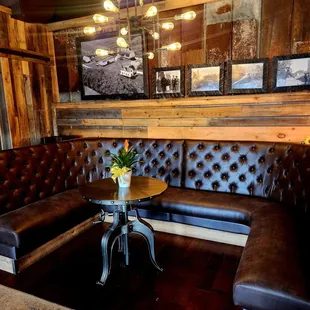 a living room with a corner couch and a table