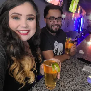 a man and a woman sitting at a bar