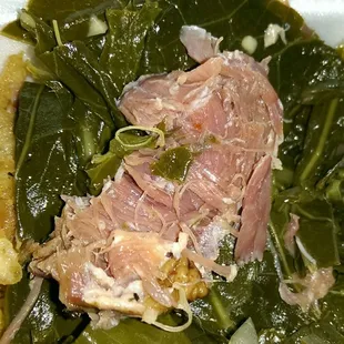 Chunks of pork in the greens.