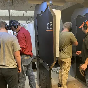 My husband &amp; FIL helping them load the guns &amp; shoot them