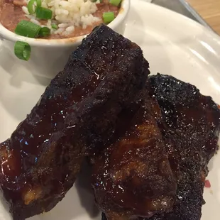 Ribs with beans and rice, baked potato and Caesar salad (not pictured)