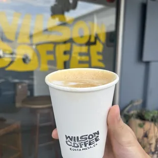 a person holding a cup of coffee