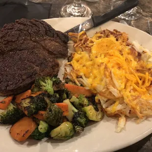 Ribeye, lyonnaise potatoes with cheese, roasted vegetables