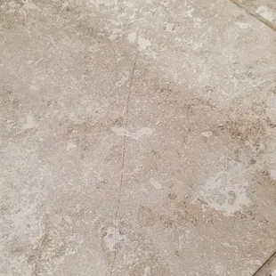 Tile cracked after only a year, because they built it too fast and don't use tighter rebar in the foundation, so it settled and caused crack