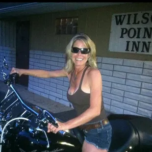 a woman sitting on a motorcycle