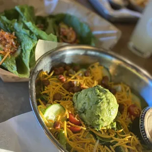 a bowl of salad and salad dressing