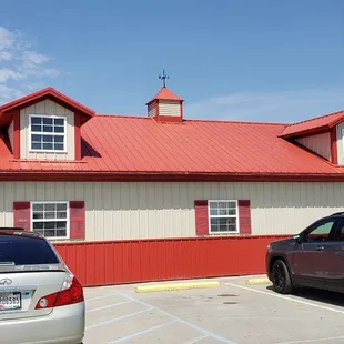 two vehicles parked in front of the building