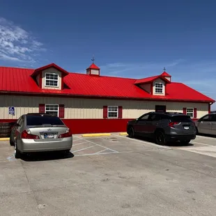 two vehicles parked in front of the building