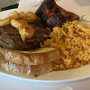 Sirloin steak with grilled shrimp, seasoned rice, smoked chicken and toast.