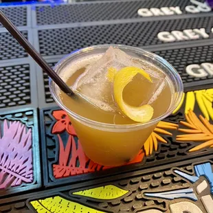 a drink in a plastic cup on a table