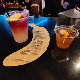 a drink and a menu on a table