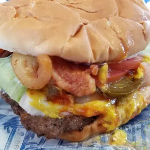 Double hamburger with cheese and bacon, plus mustard, ketchup, pickles, onions, mayo, lettuce, tomato and jalapeno. Old fashioned good food!