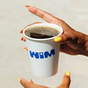 a person holding a cup of coffee