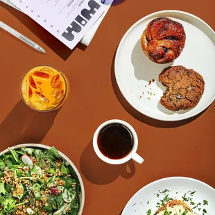 a table with plates of food and drinks