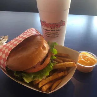 Wimpy burger with fries and cheese sauce on the side.