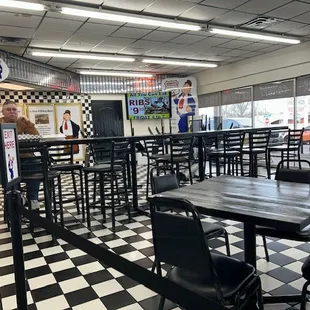 a man standing in the middle of a checkered floor