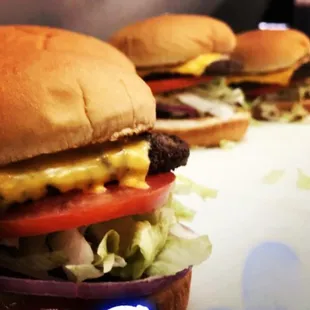 two hamburgers with cheese and lettuce