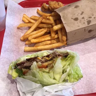 Lettuce wrapped burger and large bag of fries