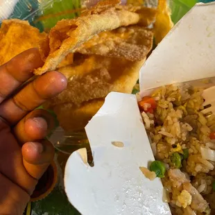 a hand holding a piece of food