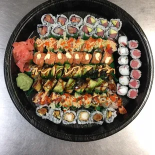 a plate of sushi and rolls