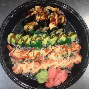 a plate of sushi and vegetables