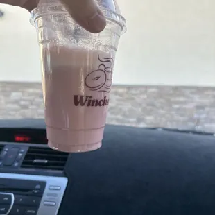 a hand holding a cup of coffee