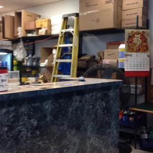 a work area with shelves and a ladder