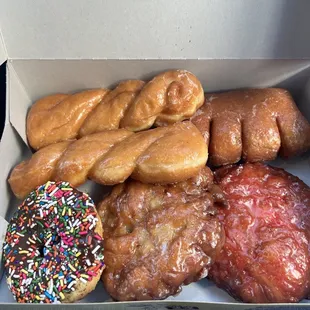 Apple fritter, Cherry fritter, bear claw, chocolate sprinkles, and two twirls