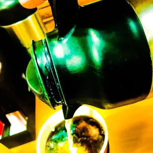 Large Regular Coffee getting its cream!